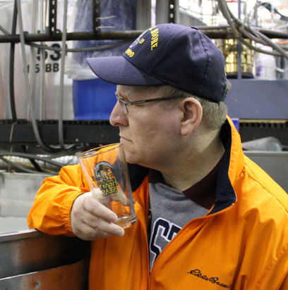 A man on the Heavy Seas Brewery tour pauses to sip and listen.