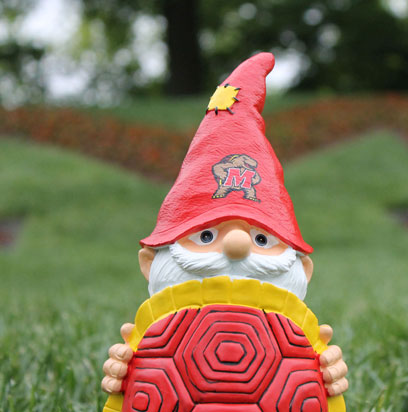 The roaming gnome strikes a classic grad pose in front of the giant welcome M.